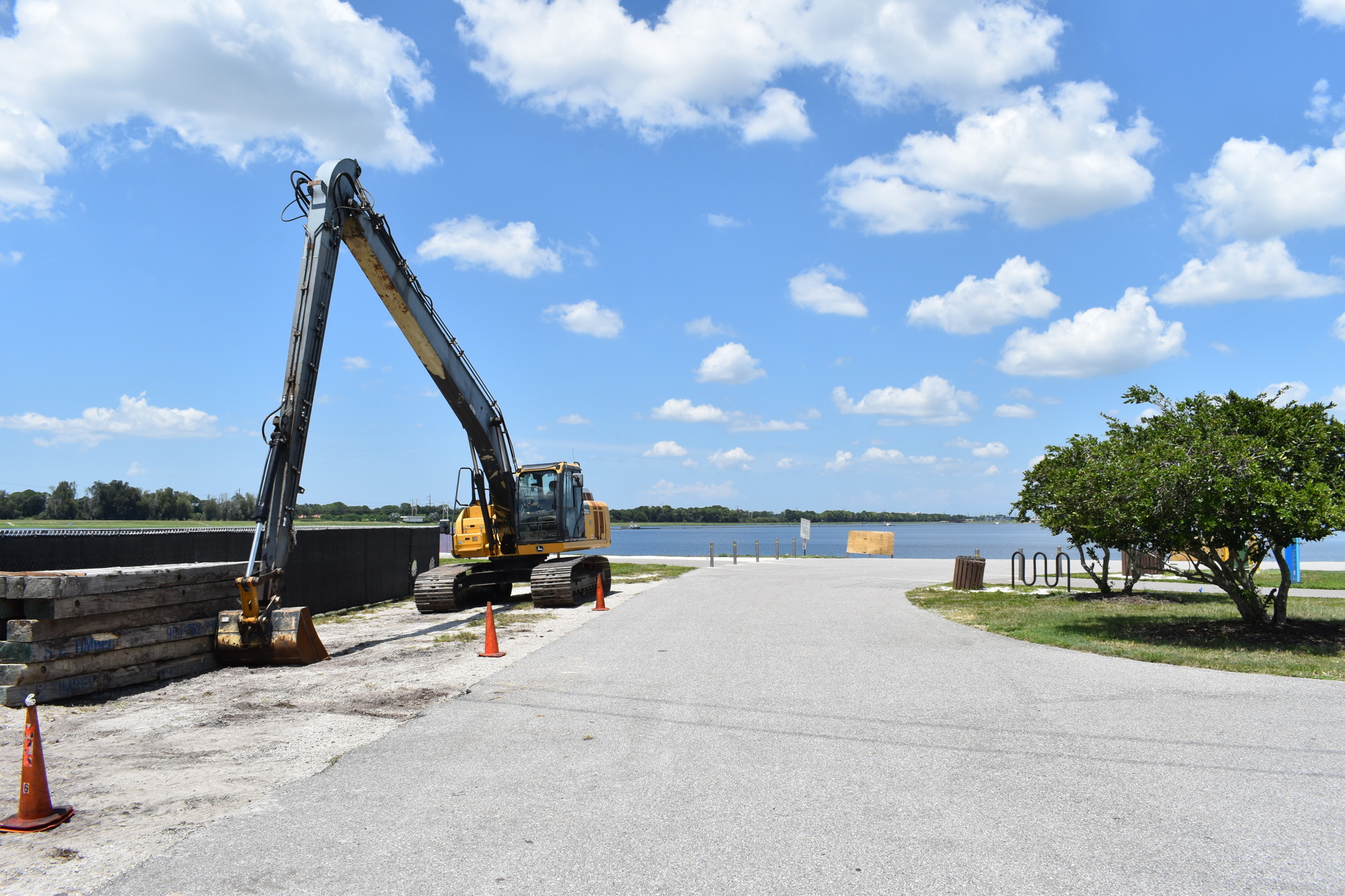 An excavator, which will be used to load riprap into the lake, stands beside the staging area next to the southeast parking lot. (Photo by Ian Swaby)