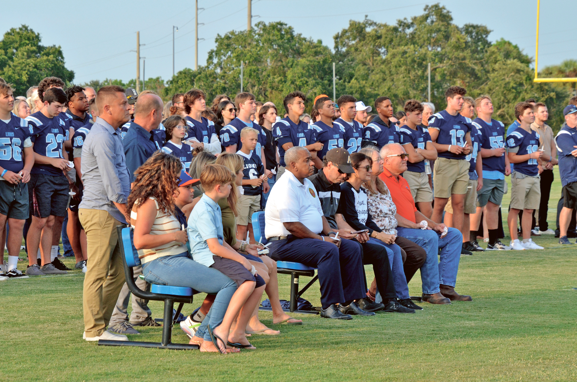The Foundation Academy football team and many folks in the community attended the candlelight vigil at the school. The Fitzgibbons, seated in center, said they are grateful for the tremendous support.