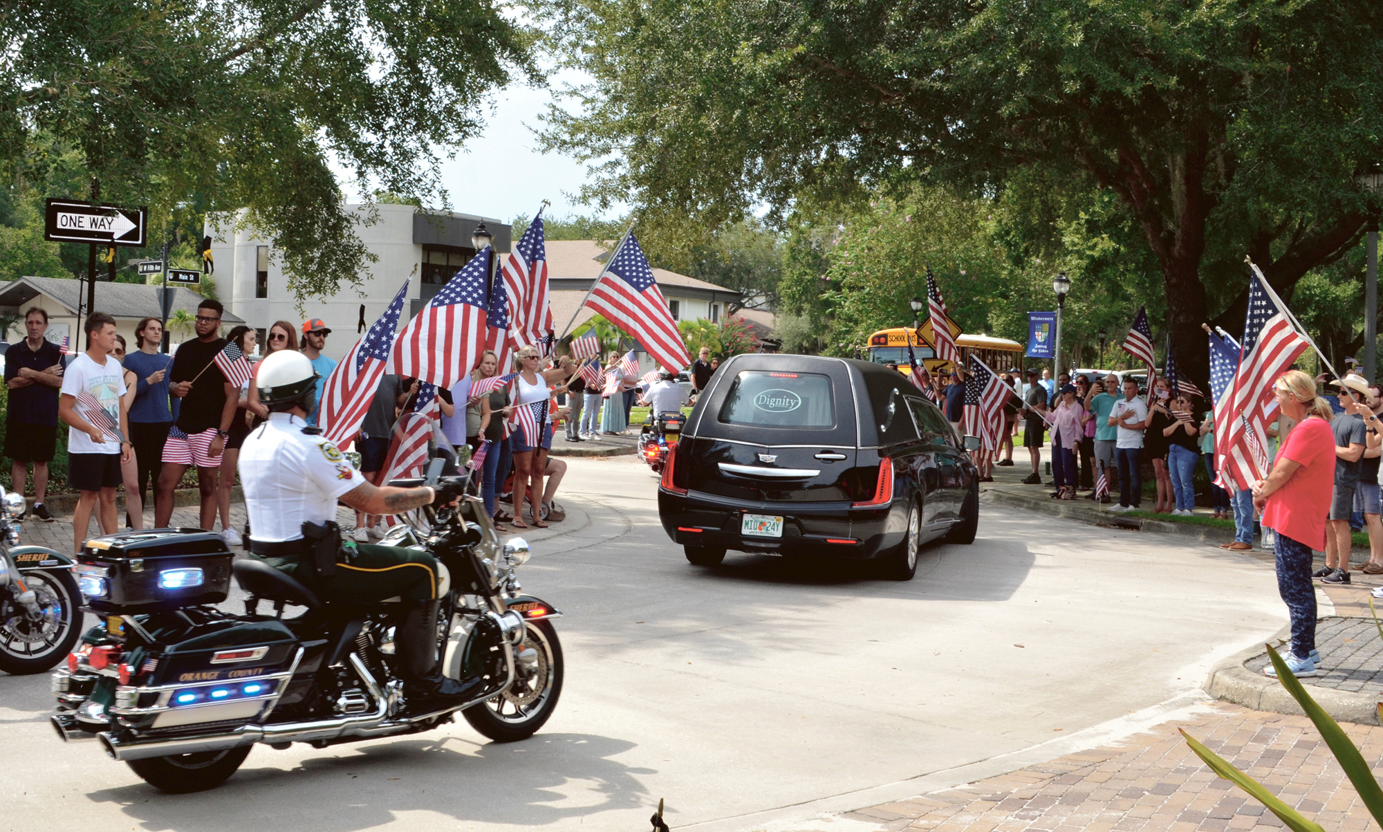 Police officers escorted the Fitzgibbon family through downtown Windermere, while friends and residents honored them with a sea of American flags.