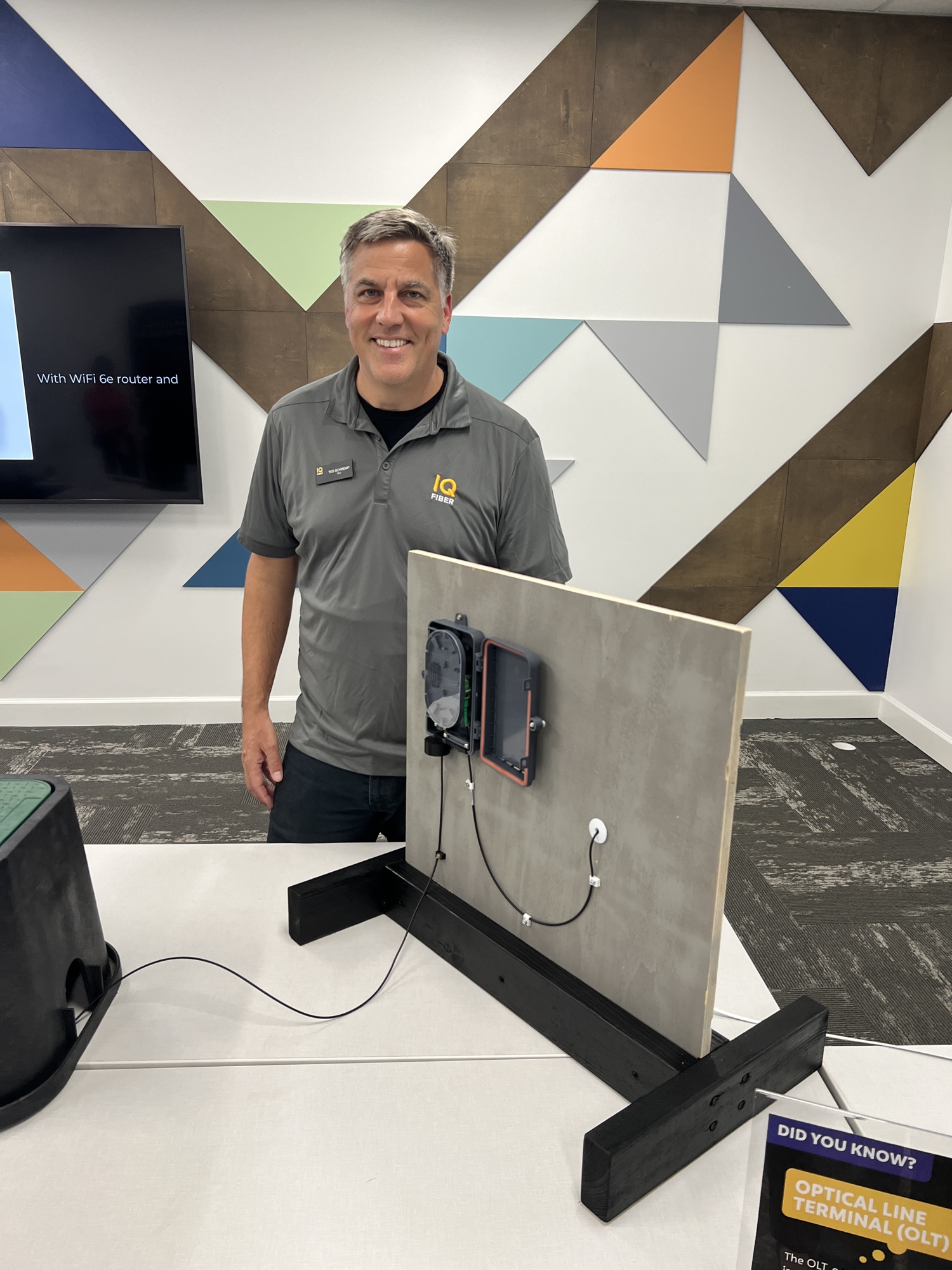 Ted Schremp, IQ Fiber CEO, shows the box that is connected to customers homes that provides the high speed internet.