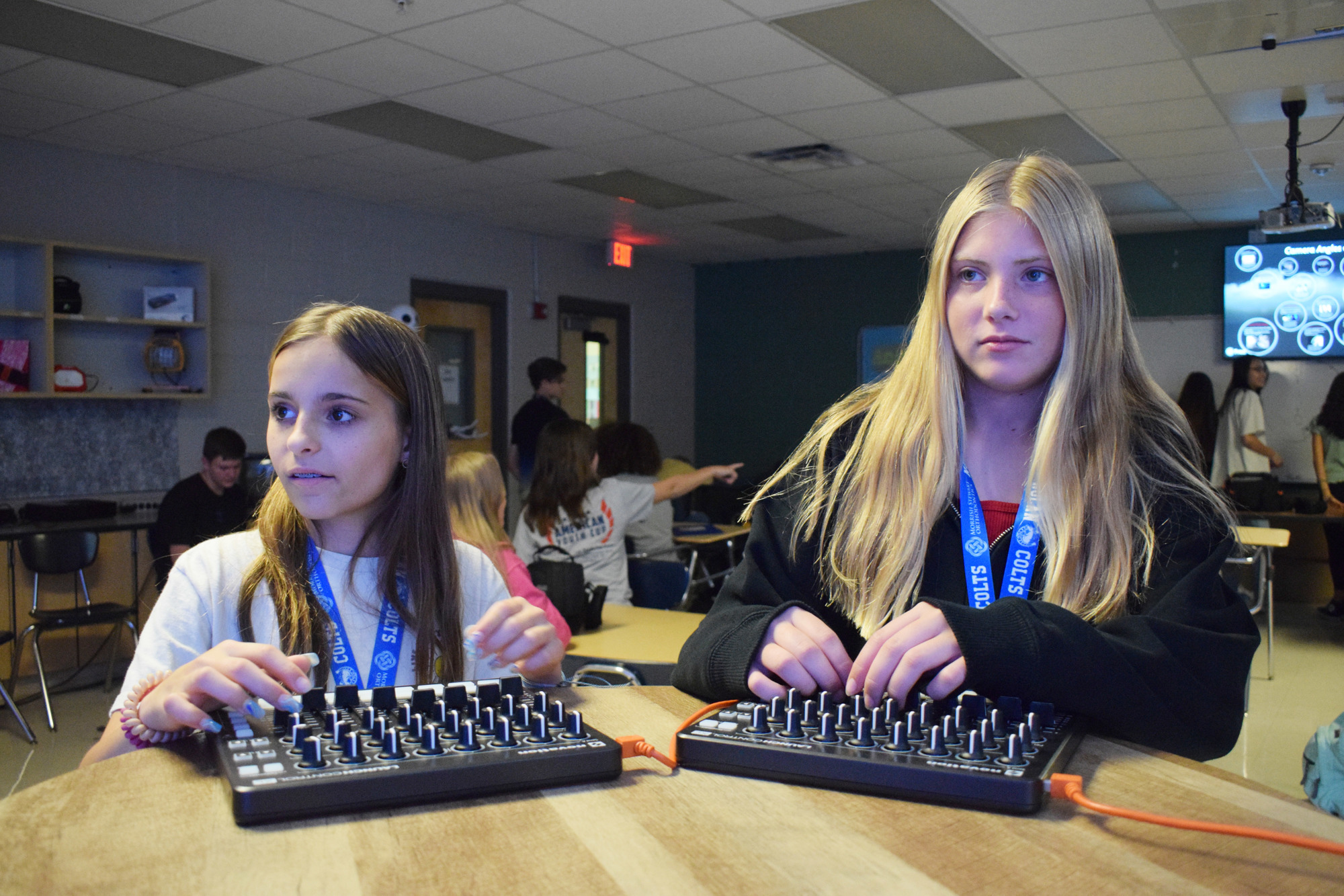 Seventh graders Juliette Aronin and Samantha Gee use switchboards to control the animatronics. (Photo by Liz Ramos)