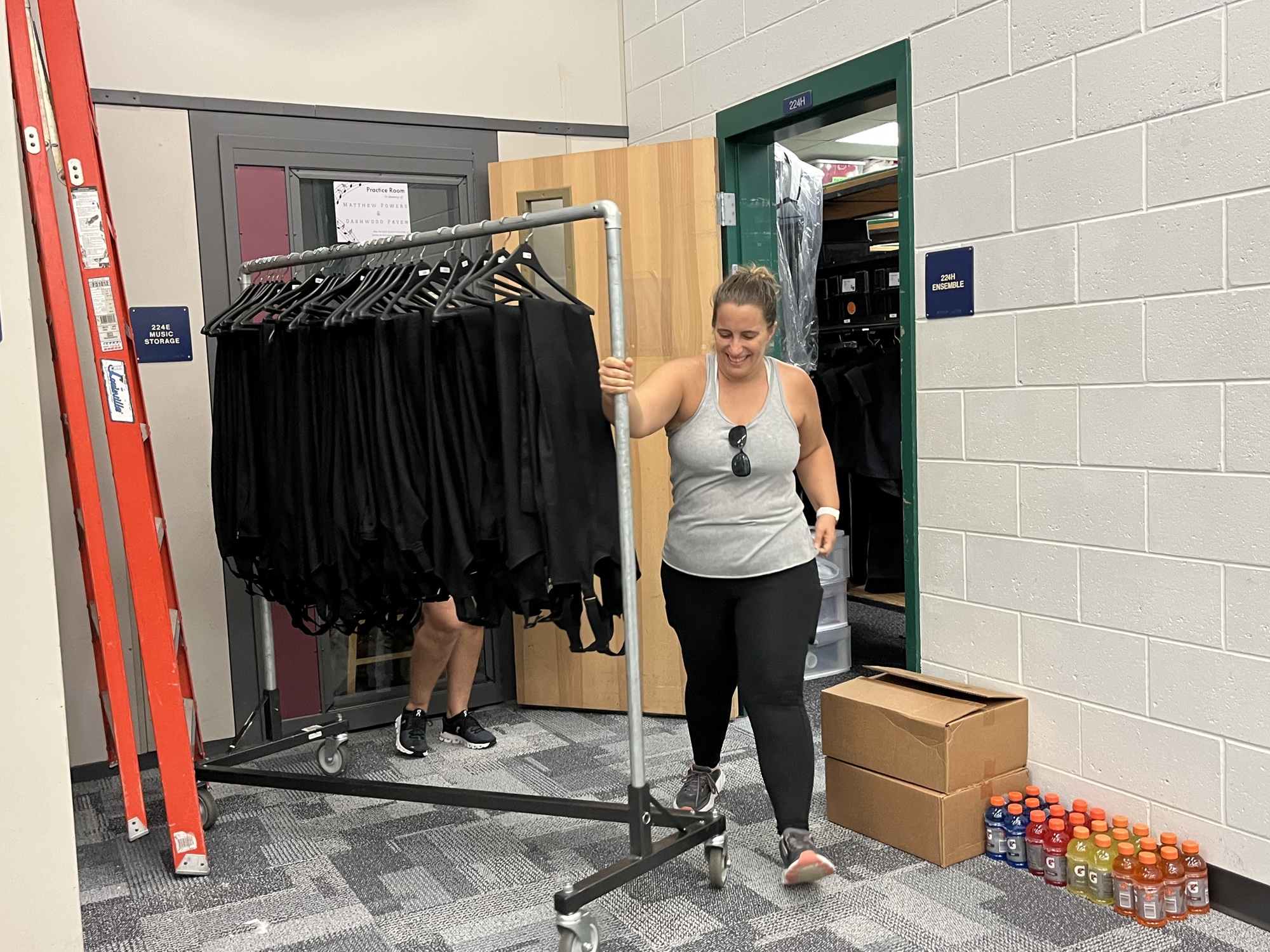 Nicole McCoy, a Lakewood Ranch High School marching band parent, brings uniforms out to the band room to make it easier for band members to have access. (Photos by Liz Ramos)