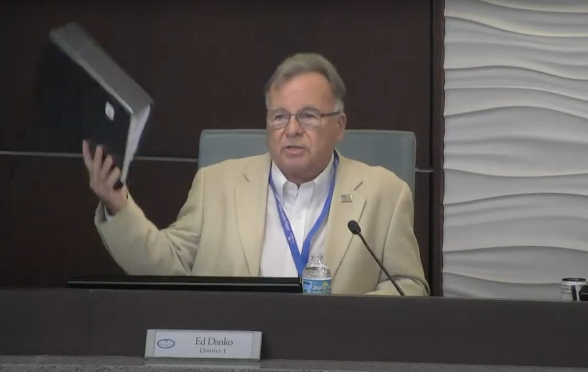 Palm Coast City Councilman Ed Danko holds up a copy of the city budget during a Sept. 8 City Council millage hearing. Image from city meeting livestream