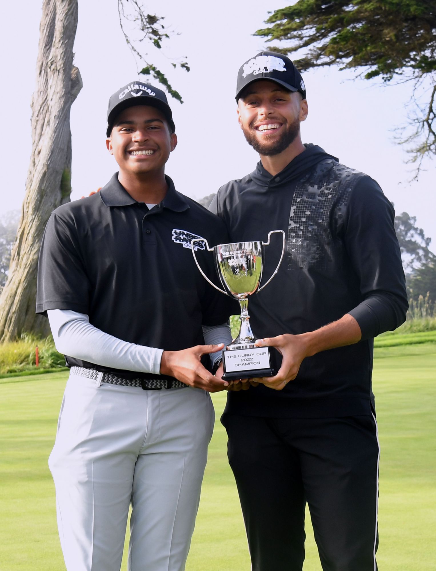 Roman Solomon poses with Steph Curry after winning the inaugural Underrated Golf Curry Cup in San Francisco. (Courtesy photo.)