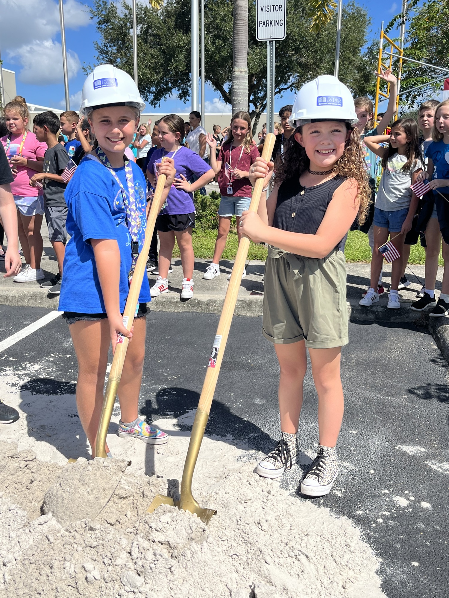 Freedom Elementary School fourth graders Lainie Prater and Jalee Harnish put on hard hats and grab shovels to celebrate the groundbreaking of their school's new addition. (Photo by Liz Ramos)
