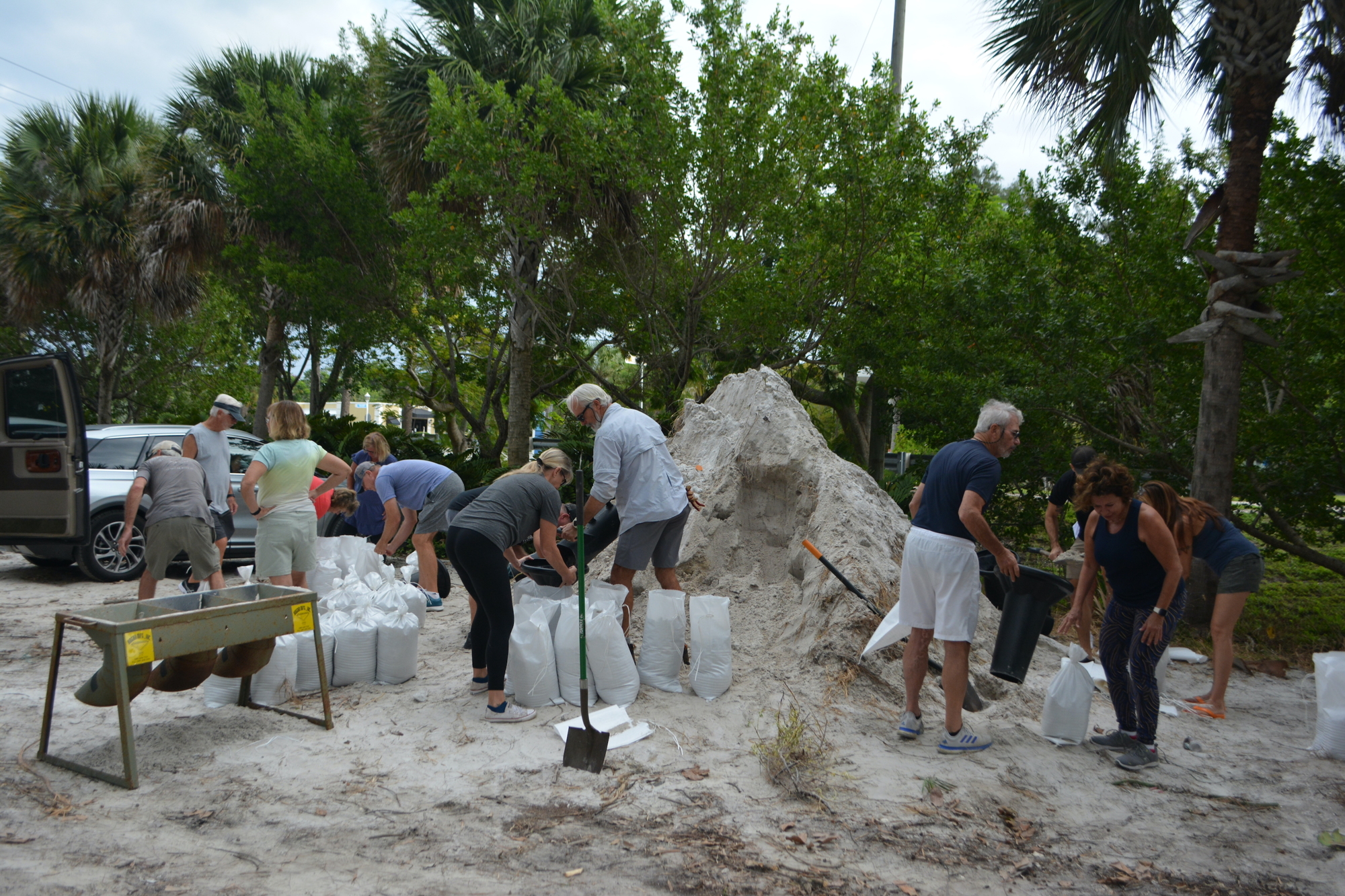Longboat Key residents gather at the Broadway Beach Access on Sunday to fill sandbags. (Photo by Lauren Tronstad)