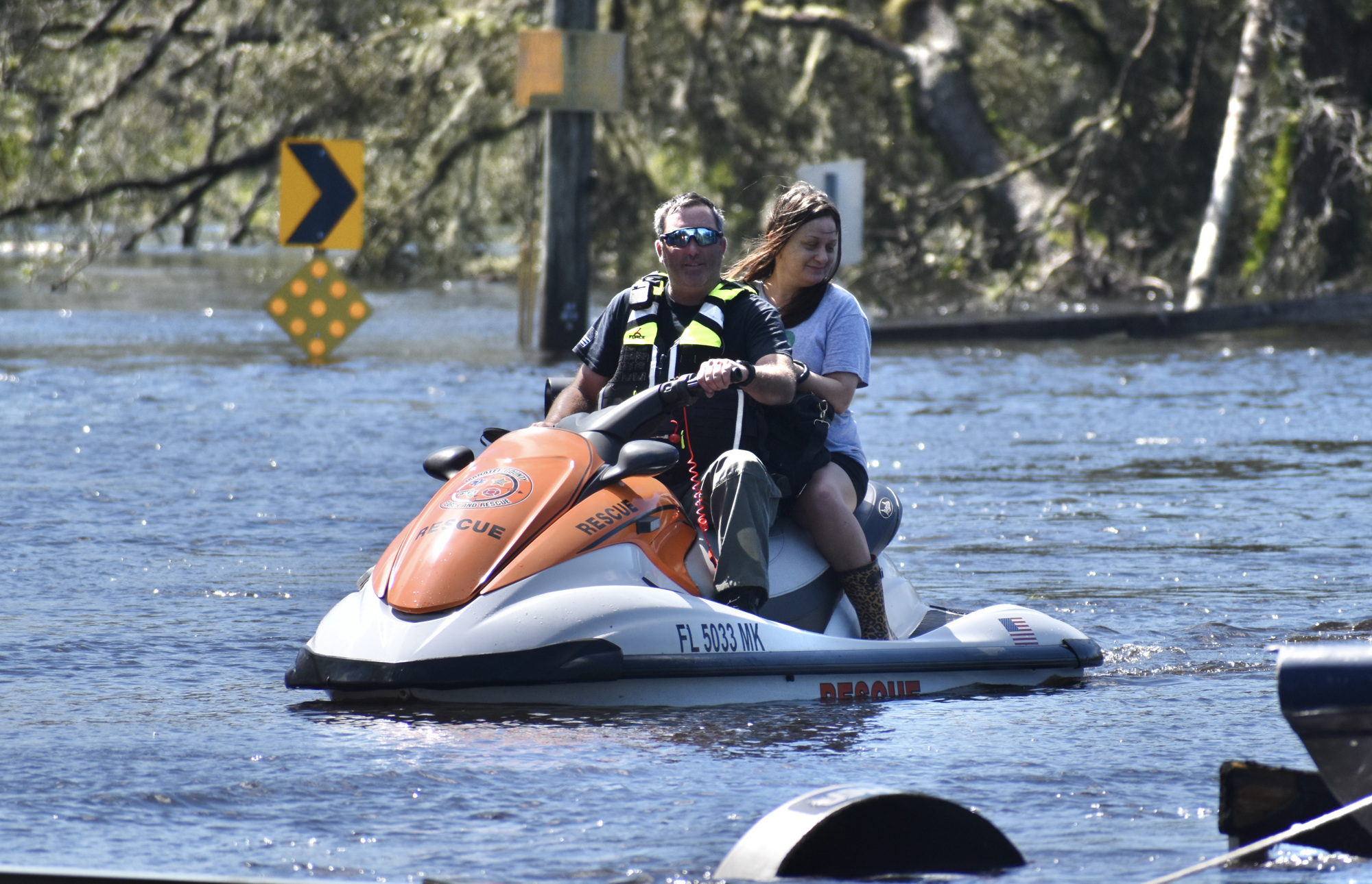 Jared Leggett rescues a woman trapped by flooding in Singletary Road. (Photo by Ian Swaby)