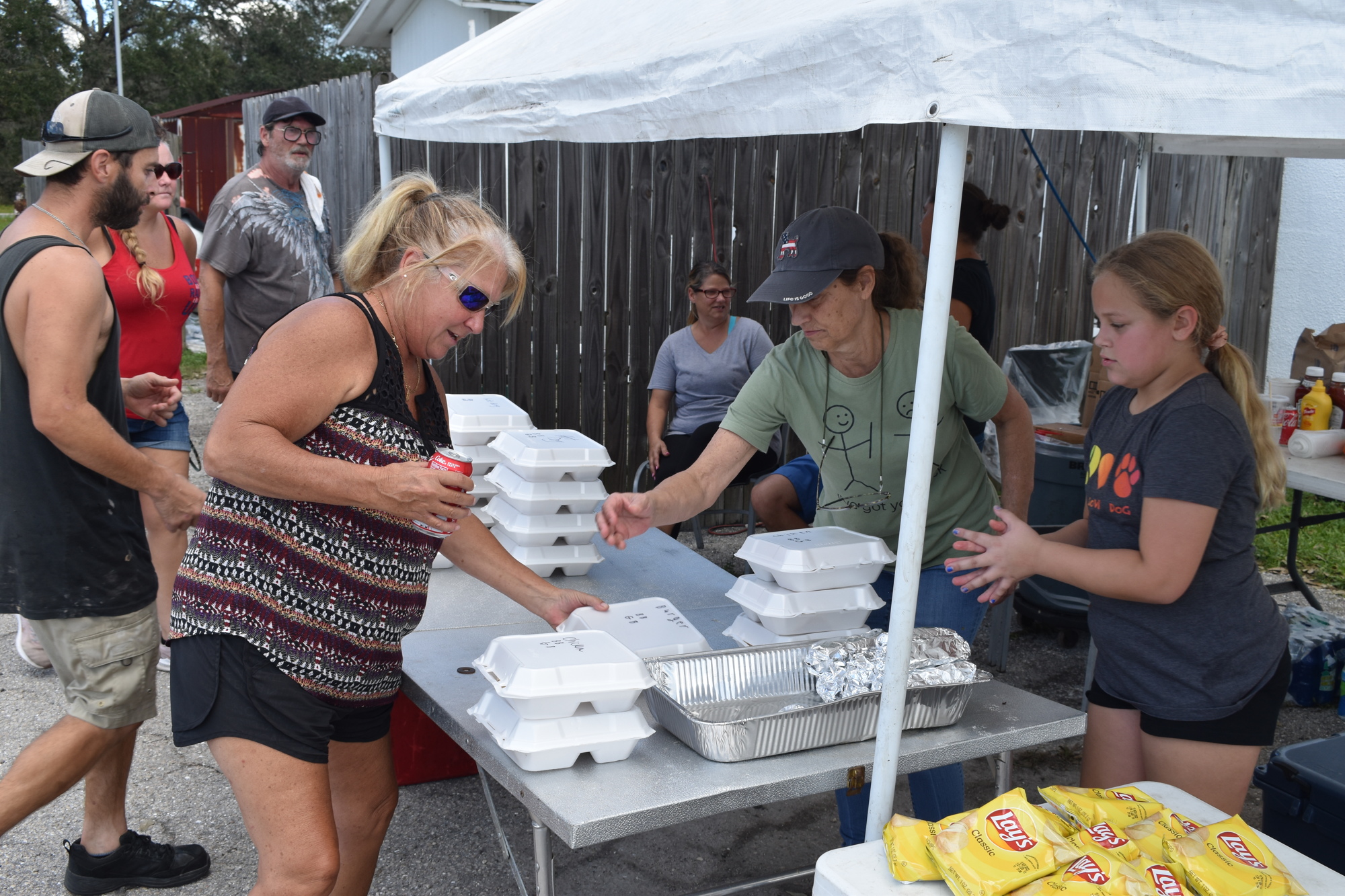 Luann Nahrwold accepts some free offerings from Vicki Krone and 9-year-old Maci Kaufman at Silver Star East. (Photo by Ian Swaby)