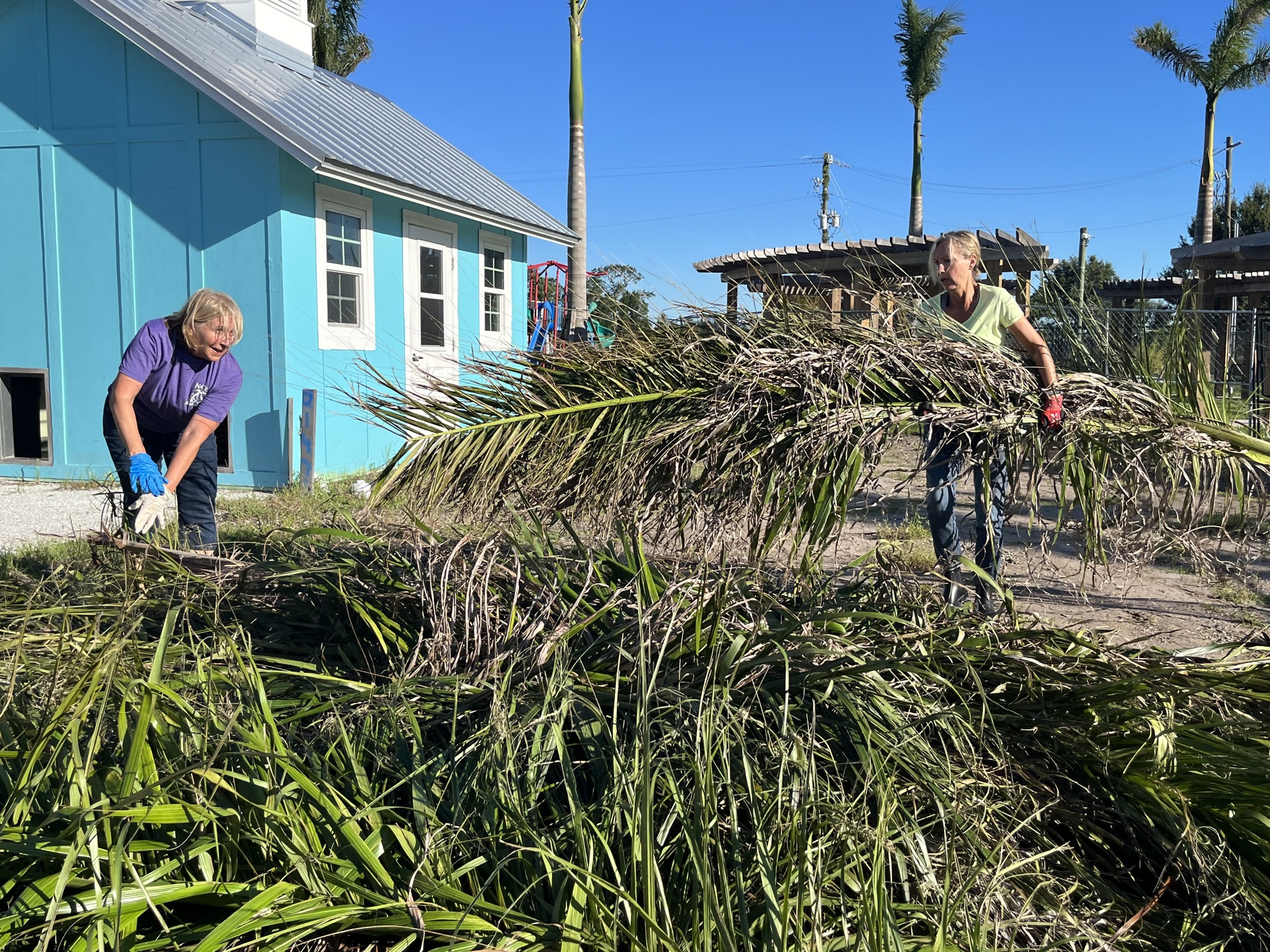 Lakewood National's Barbie Osterling and Waterside's Jill Hennessey volunteer to help clean up Nate's Honor Animal Rescue after Hurricane Ian. The nonprofit saw limited damages from the hurricane.