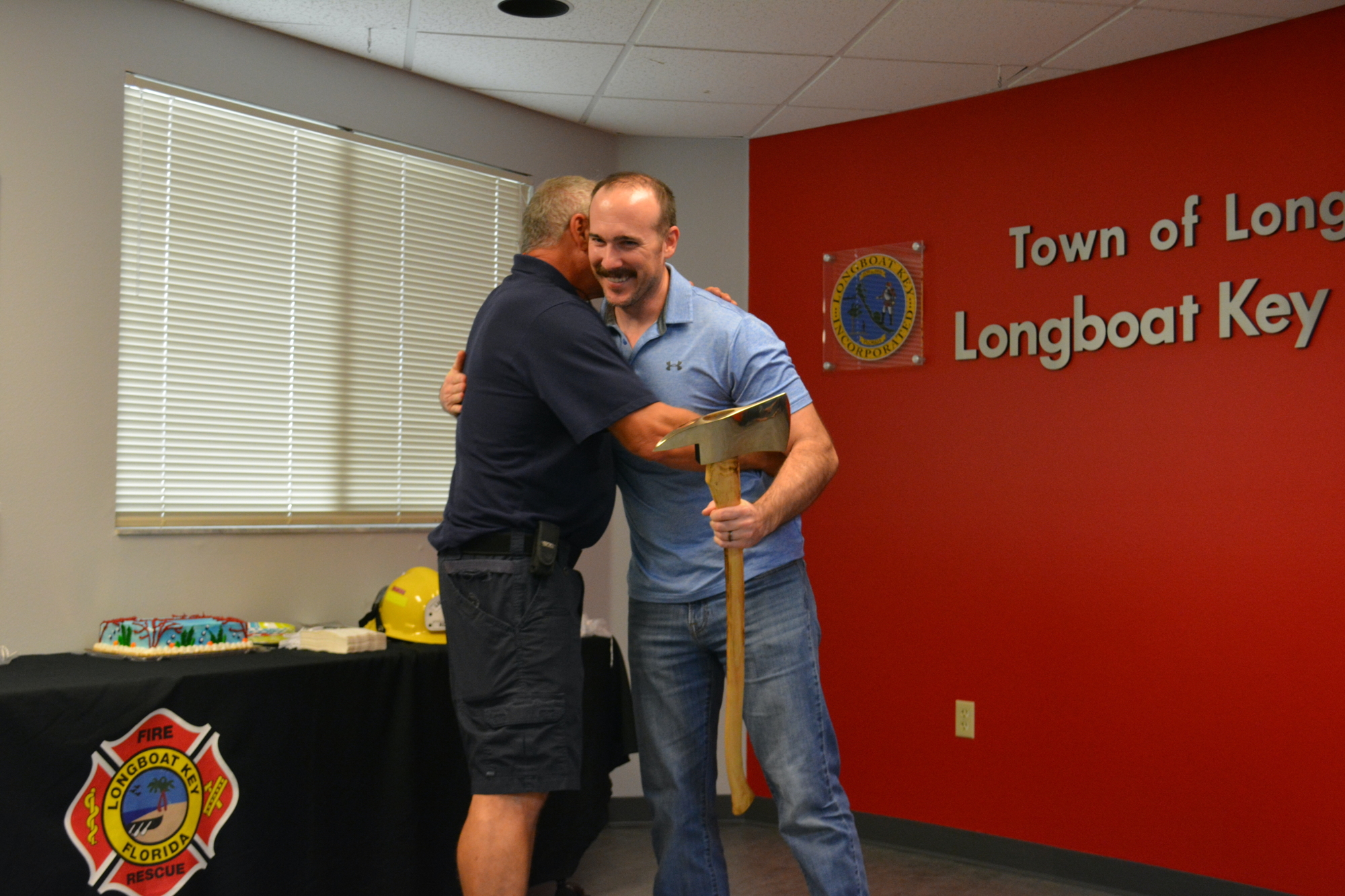 Lt. Alan Jenkins, right, hugs firefighter-paramedic Jeff Bullock at his retirement ceremony Monday. (Photo by Lauren Tronstad)