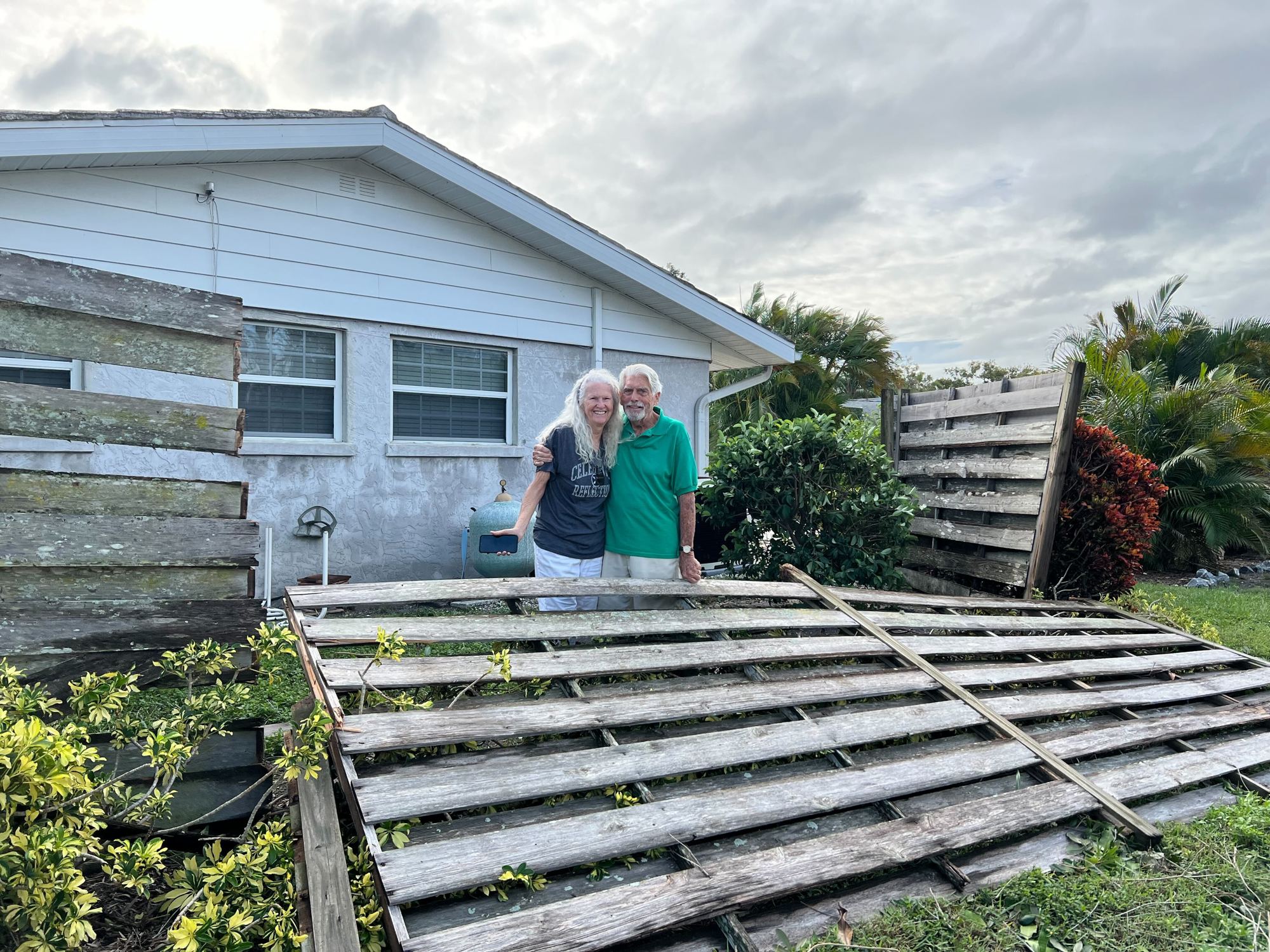 Pat and Hugh Beetham rode out the storm in their son’s house and came back to find their fence down in South Gatre. (Photo by Kat Hughes)