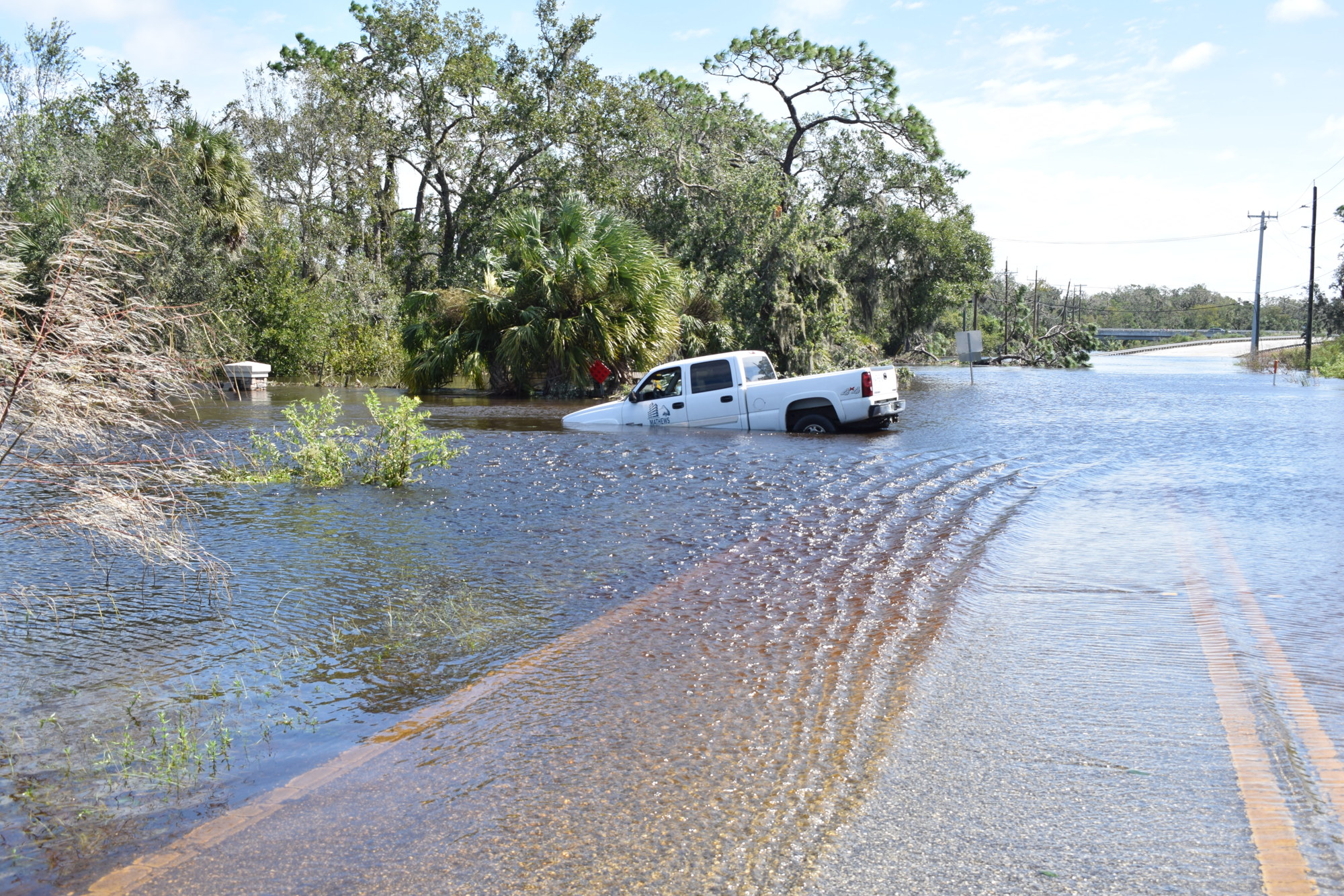 Manatee County officials urged motorists not to drive into standing water. Here a pickup truck is covered by floodwaters on Upper Manatee River Road. (Photo by Jay Heater)