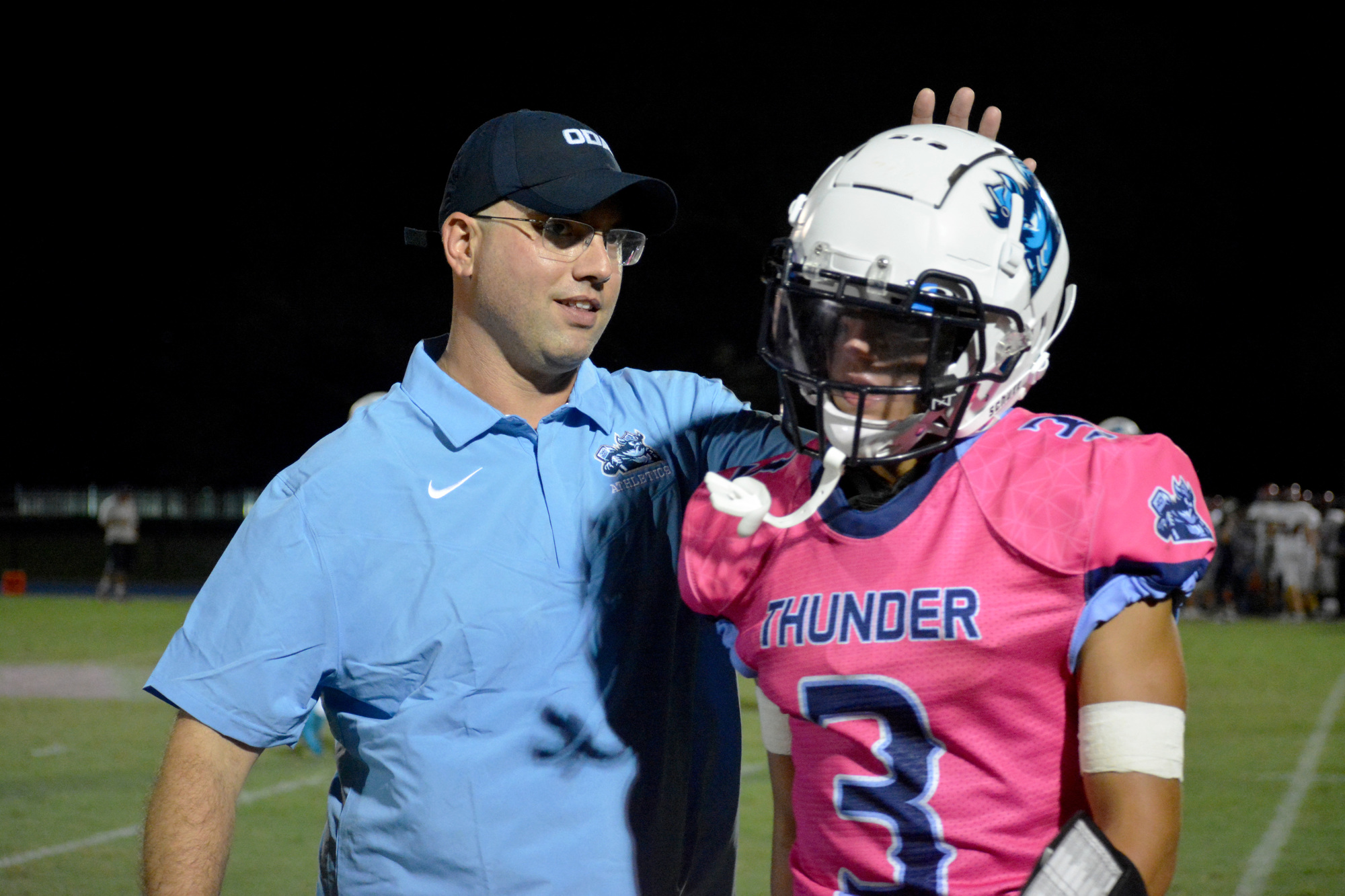 ODA Head Coach Rob Hollway gives senior Michael Luedeke a tap on the helmet after strong kickoff coverage. Hollway said he tries to emulate 