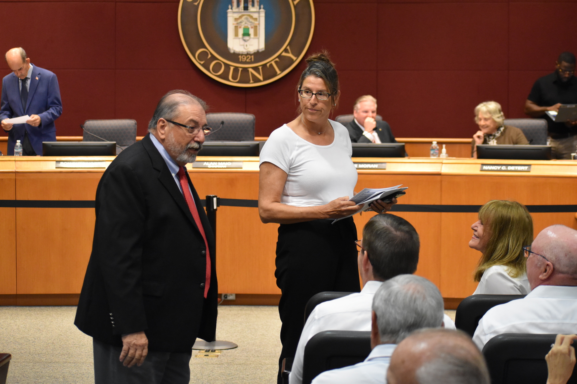 Commission Chair Alan Maio interacts with the crowd, including Waterside's Maureen Weihs, before the commission meeting began Tuesday. (Photo by Ian Swaby)