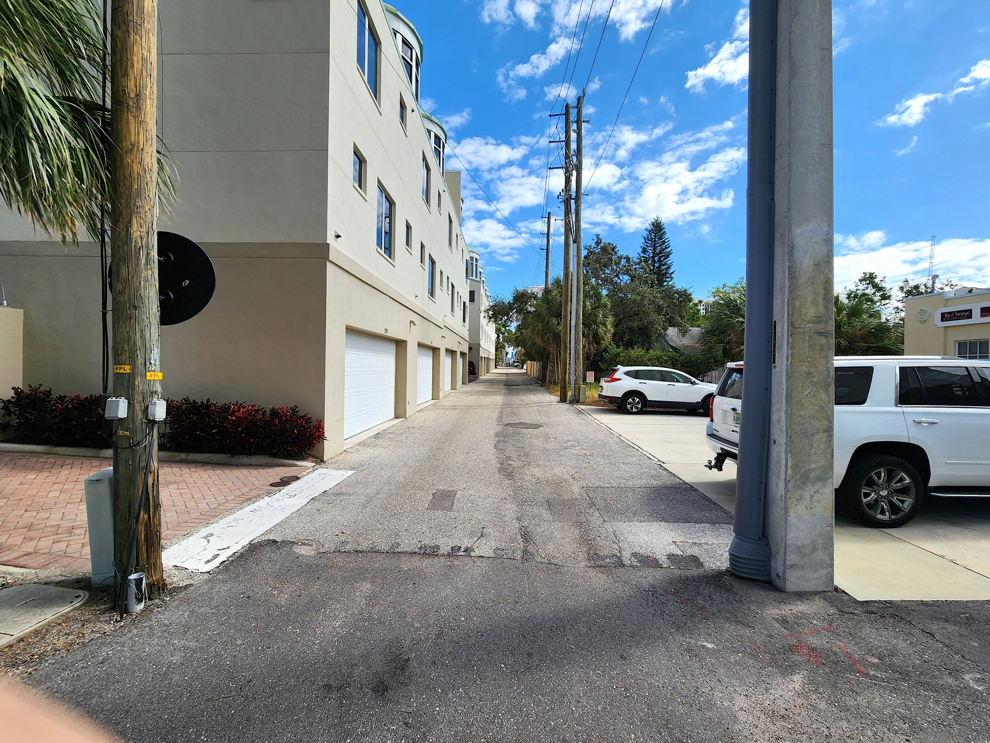 This alley between townhomes along Fruitville Road and Second Street is currently used for garage access for the townhomes, parking for Second Street businesses and service vehicles for the Embassy Suites. (Andrew Warfield)