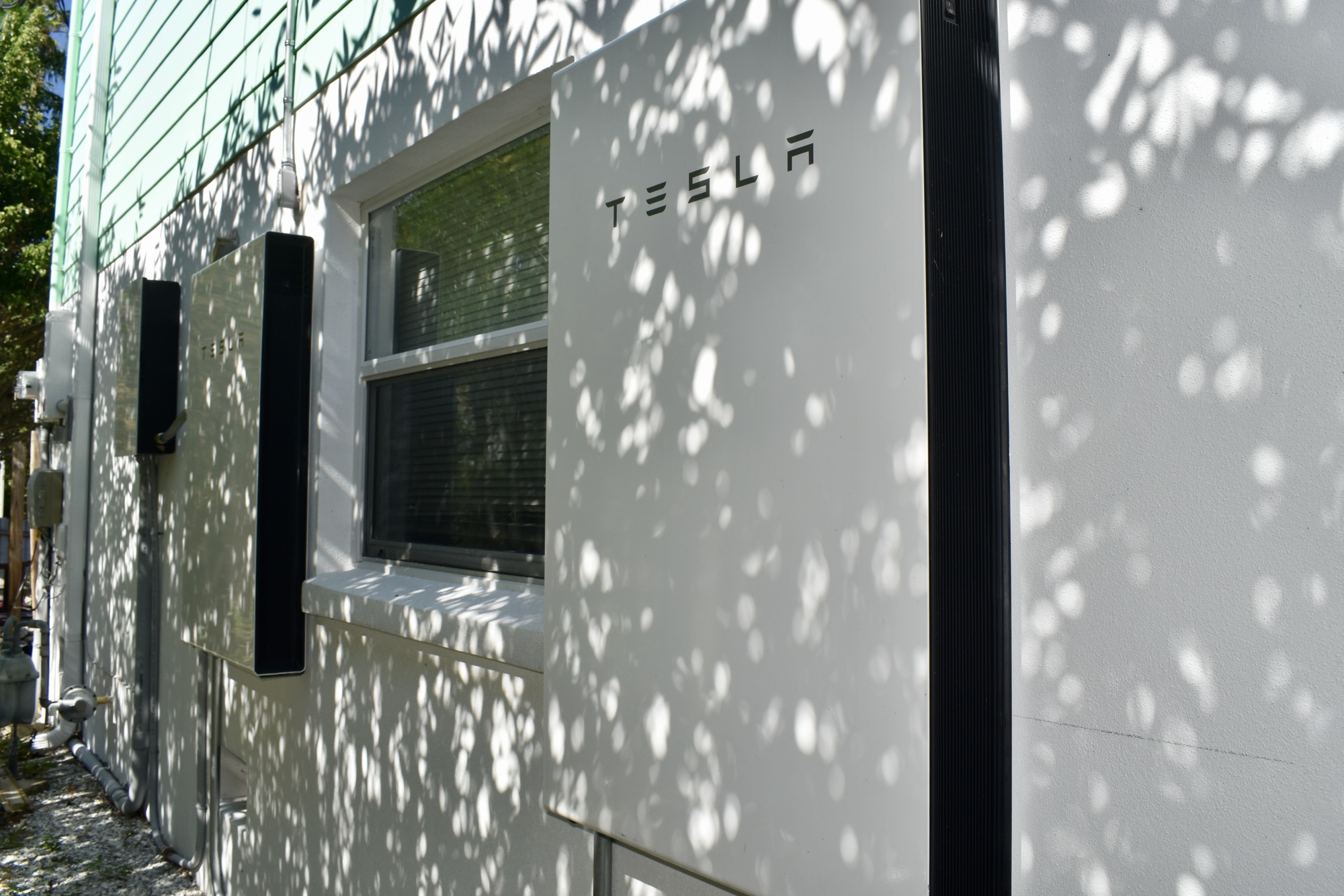 The Powerwall backup system installed on the side of Rusty Chinnis and Chris Killeen's house. They have two Tesla Powerwalls to use as backup through power outages. (Photo by Lesley Dwyer)