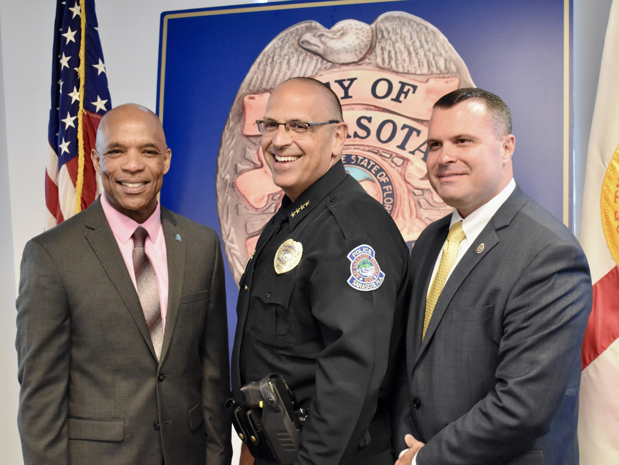 City Manager Marlon Brown, Police Chief Rex Troche and Deputy City Manager Pat Robinson pose for a photo after Troche was sworn in.