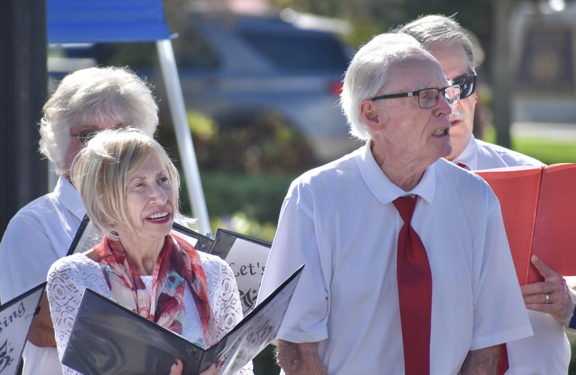 Let's Sing members, Del Webb's Ivy Ruark and Jerry Scoville, sing God Bless America. (Photo by Ian Swaby)