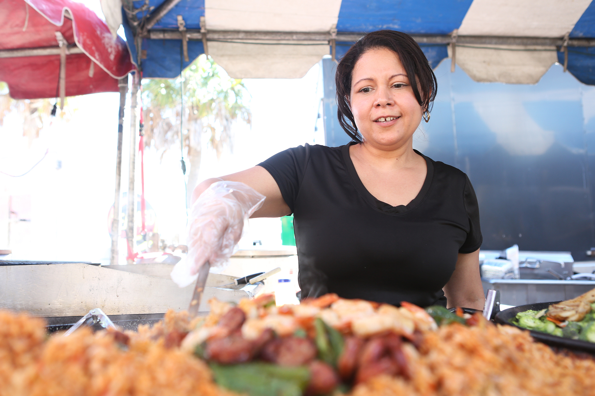Lilian Prado tends to the seafood at the 2021 Siesta Beach Seafood & Music Festival.