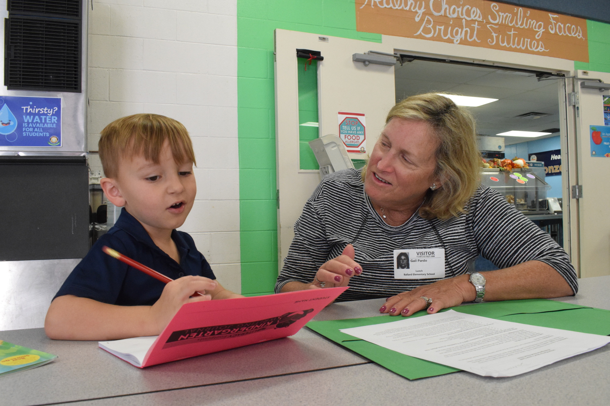 Ballard Elementary School kindergartner Damon Presthus gets help spelling 