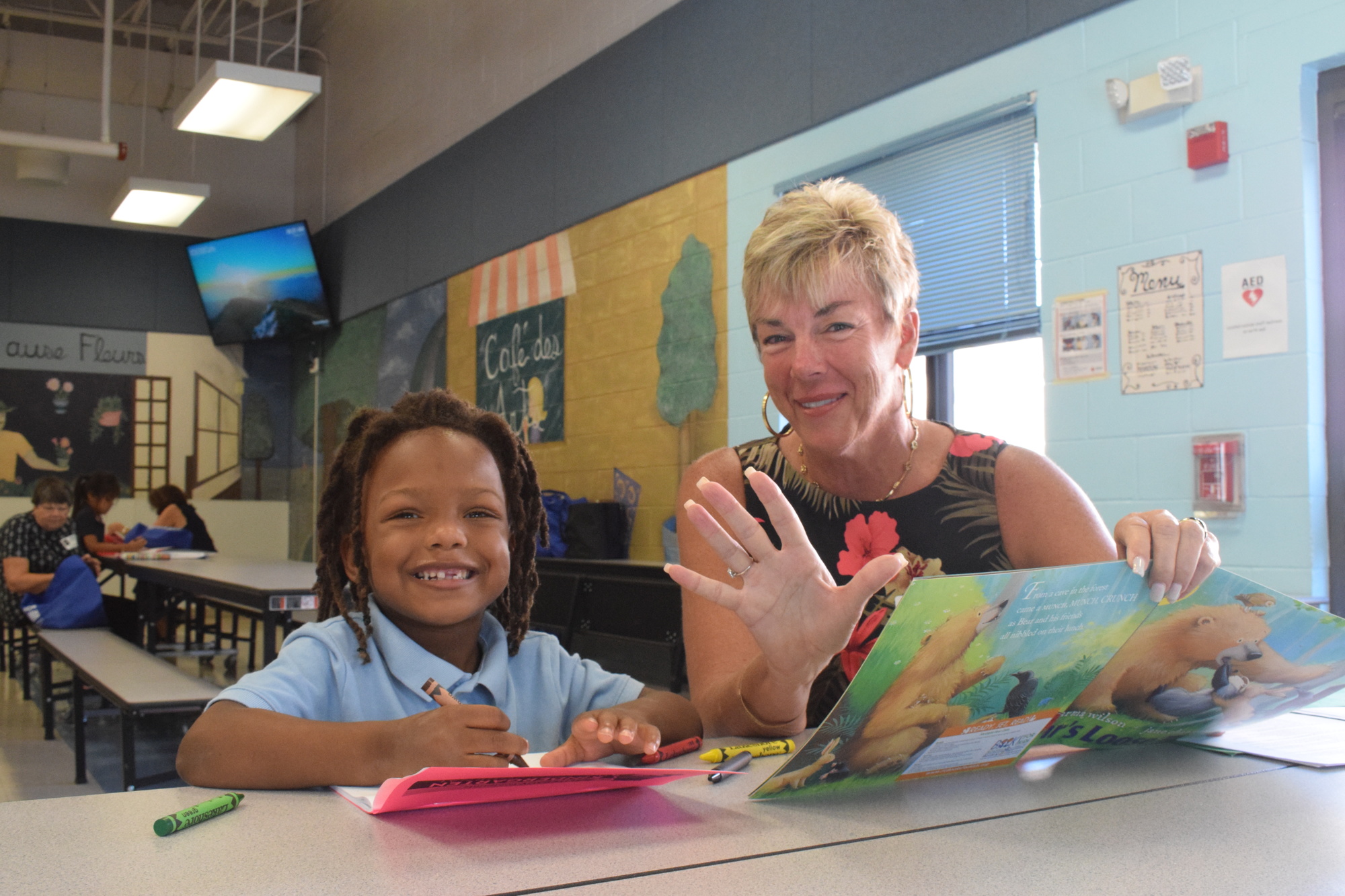 James Cooper, a Ballard Elementary kindergartner, has fun working on literacy activities with Lakewood Ranch's Janet Hoffman. (Photo by Liz Ramos)