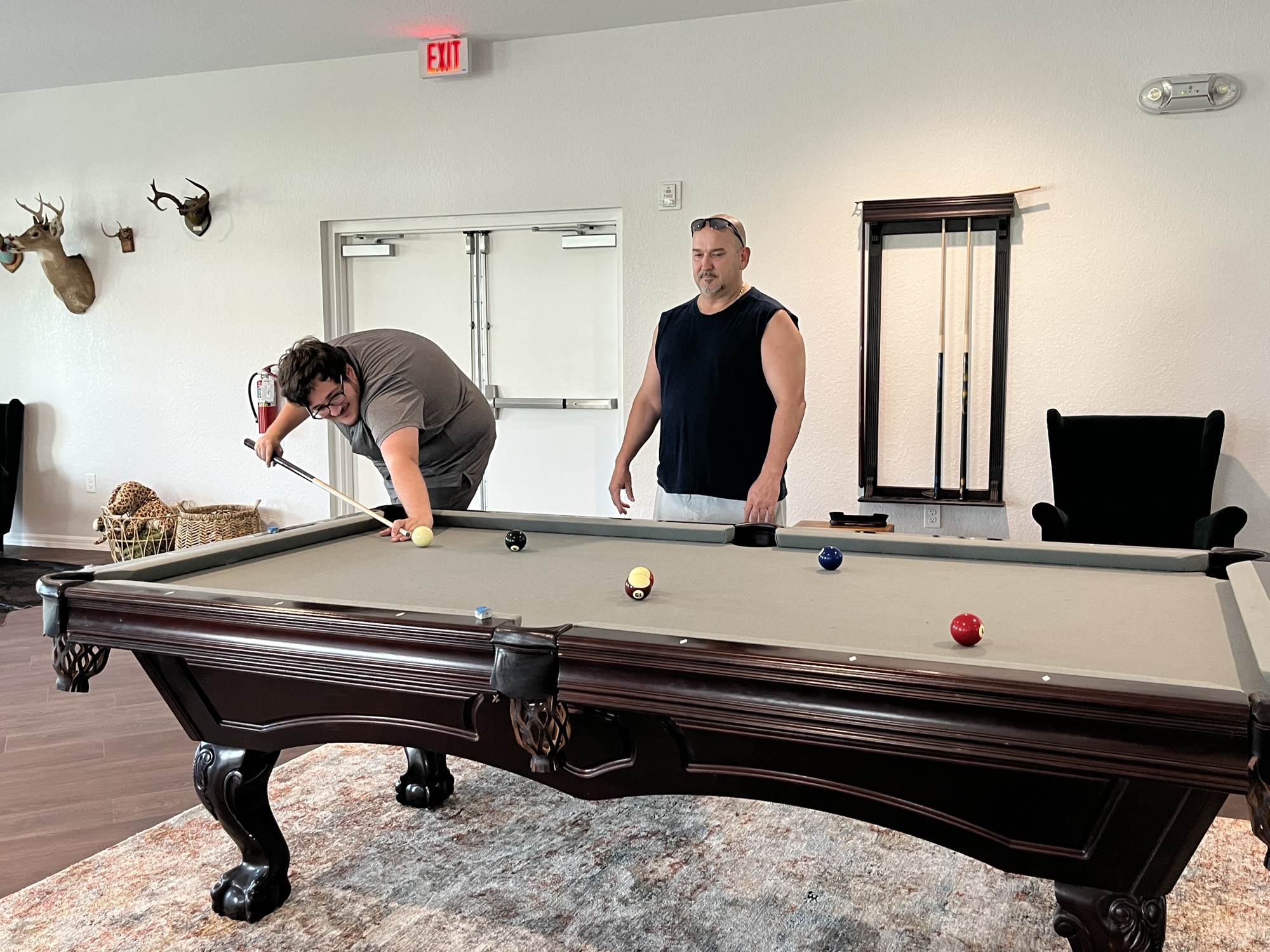 Bryson Babineaux plays pool with his dad, Brandon Babineaux in the clubhouse. The Babineauxs, who are insurance adjusters, are staying at Linger Lodge RV Park helping in the aftermath of Hurricane Ian. (Photo by Liz Ramos)