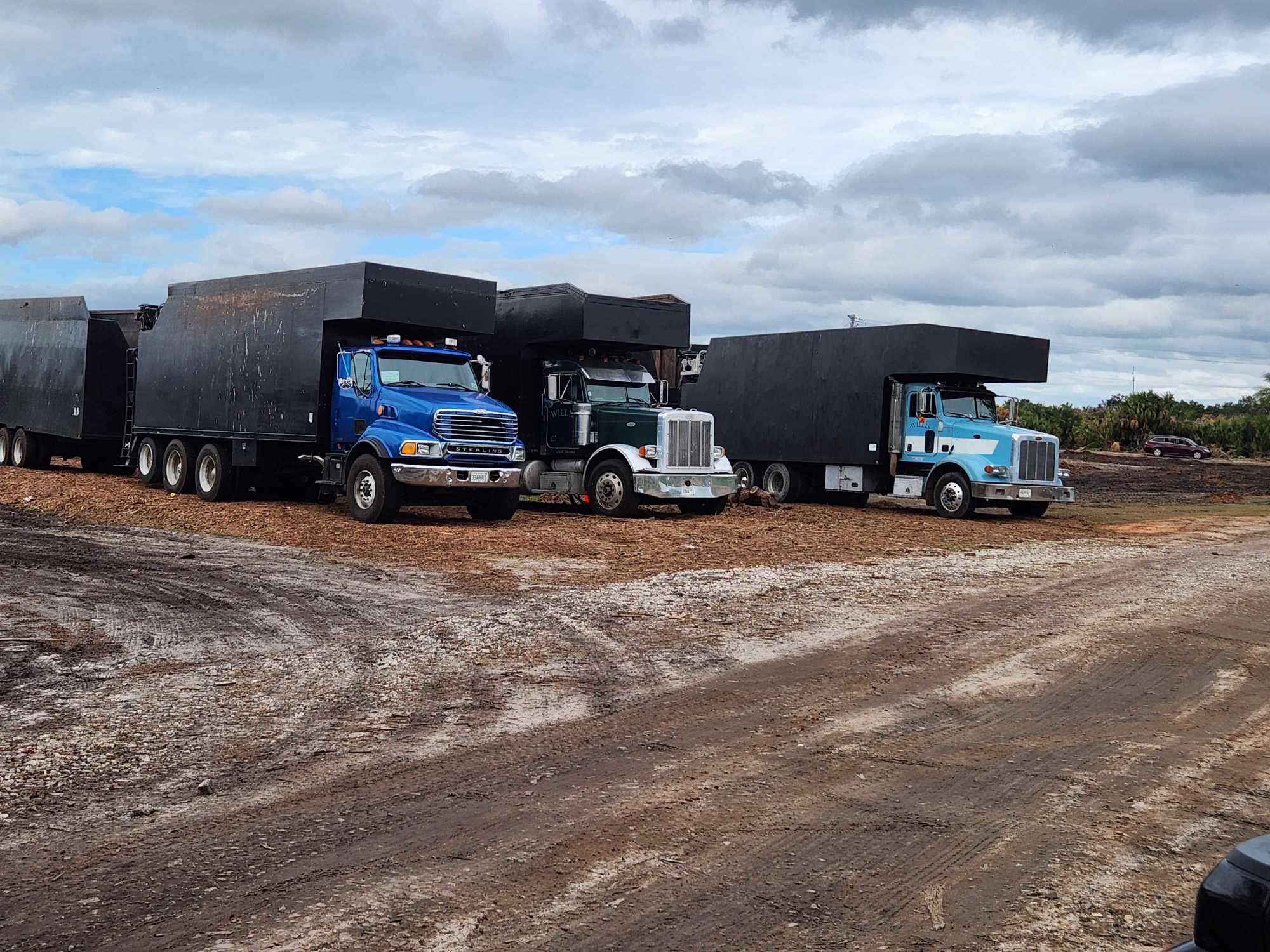 Vegetative debris haulers await deployment at the delivery site off Dr. Martin Luther King Jr. Way in Sarasota. (Andrew Warfield)